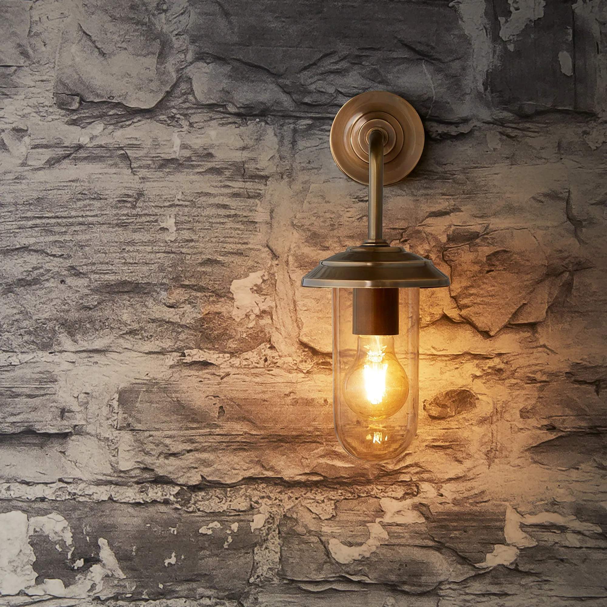 Curlew IP44 wall light in antique brass