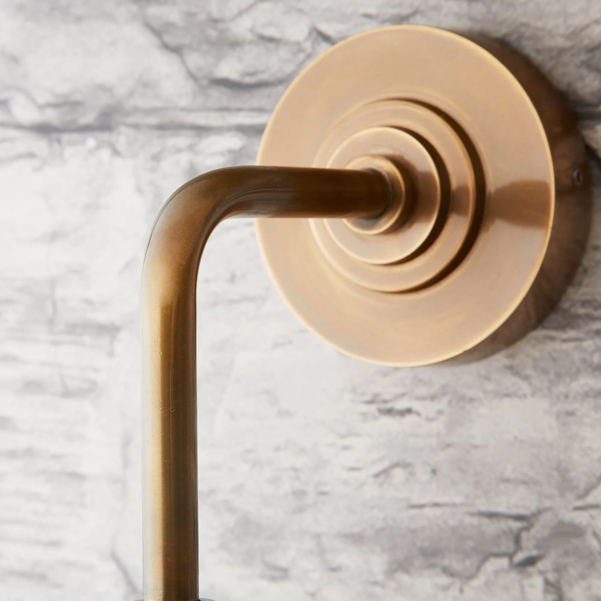 Curlew IP44 wall light in antique brass