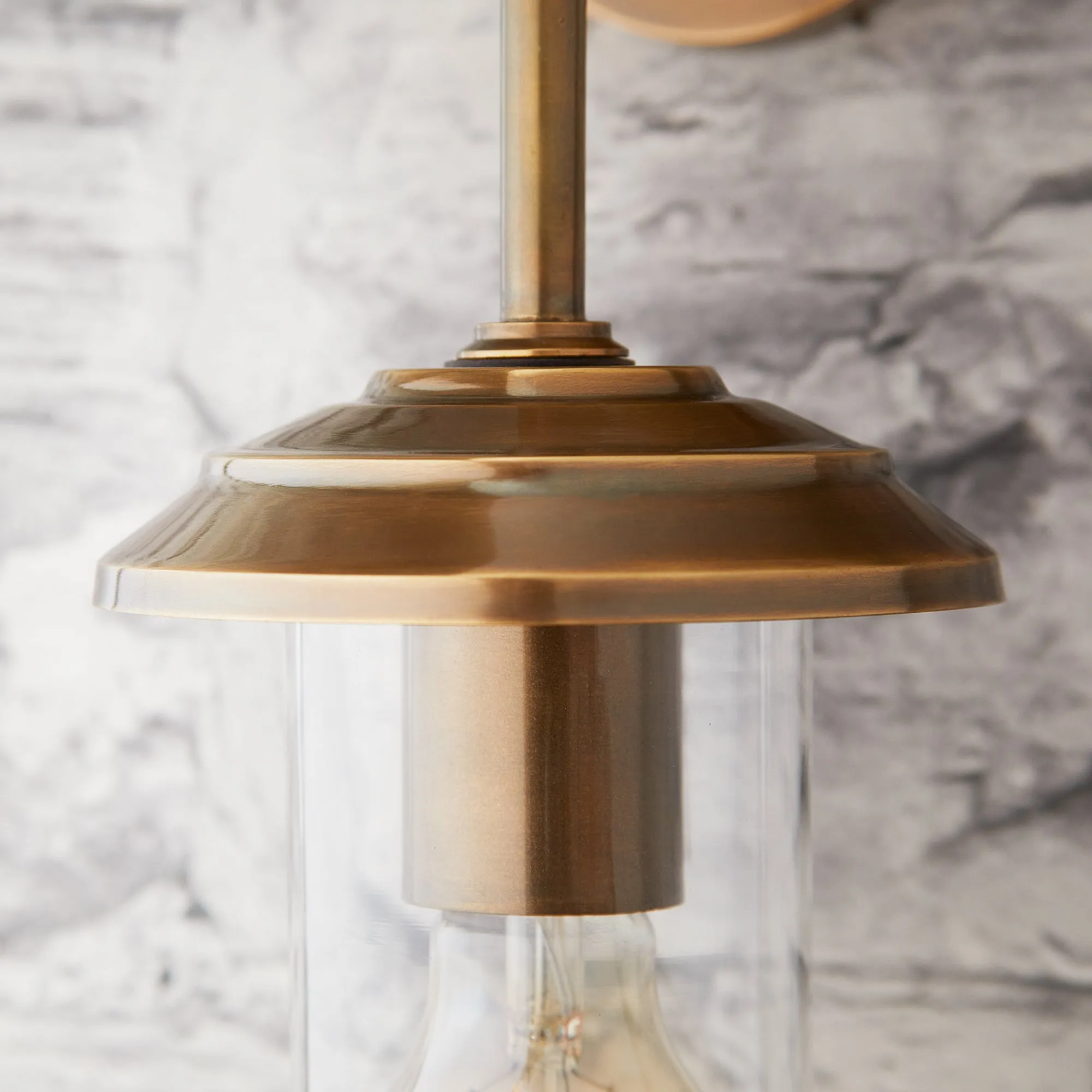 Curlew IP44 wall light in antique brass