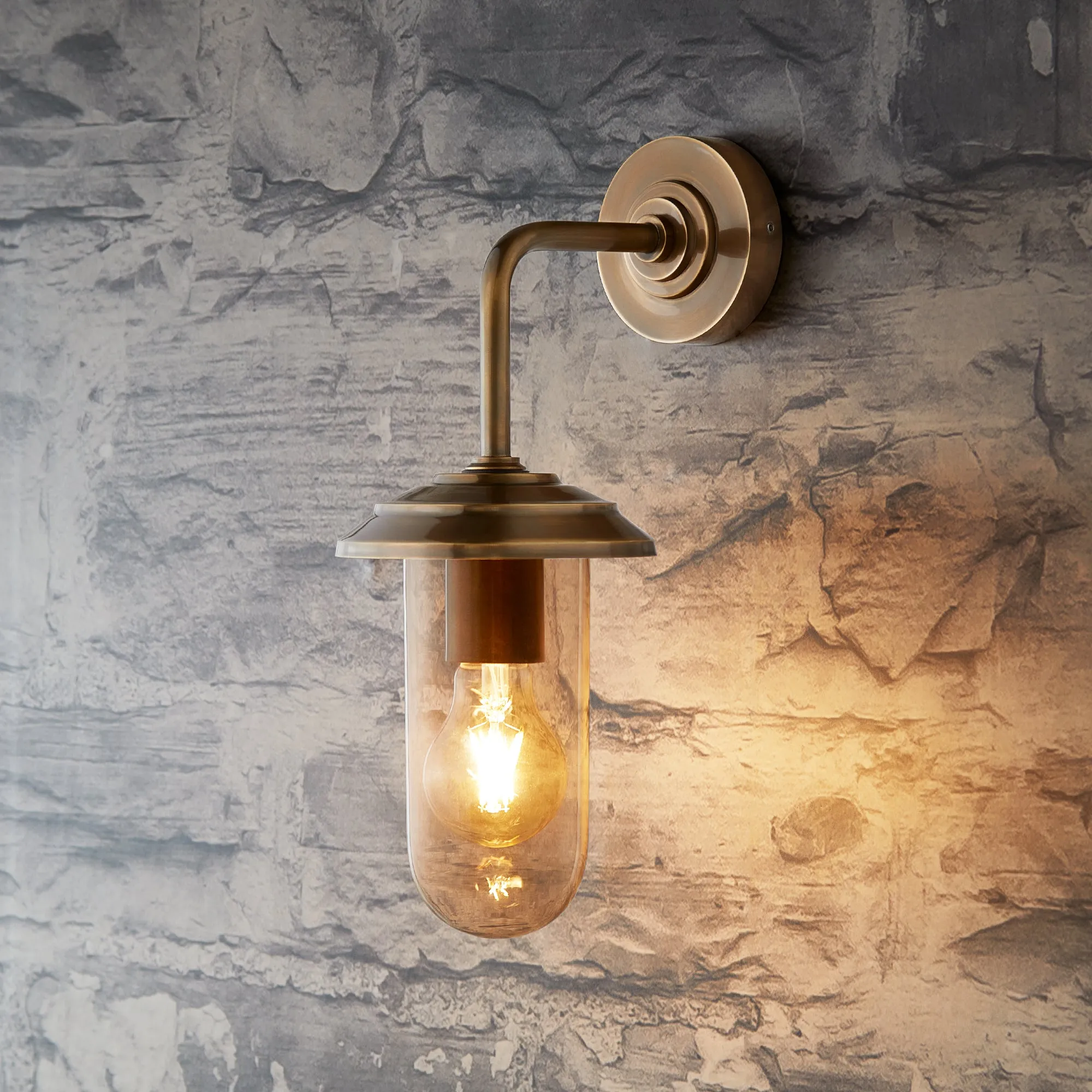 Curlew IP44 wall light in antique brass